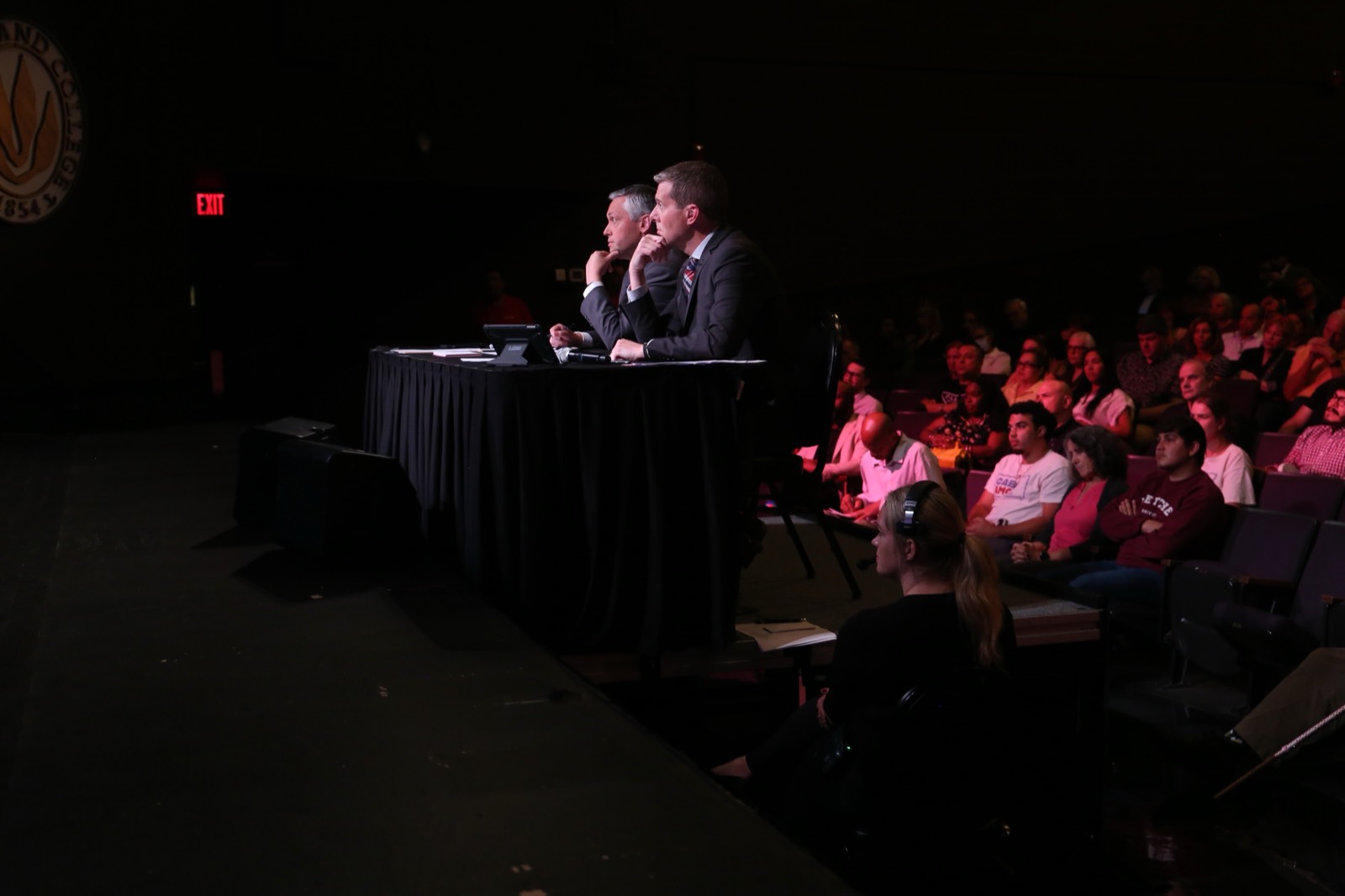 Tim White at the moderator desk during a debate