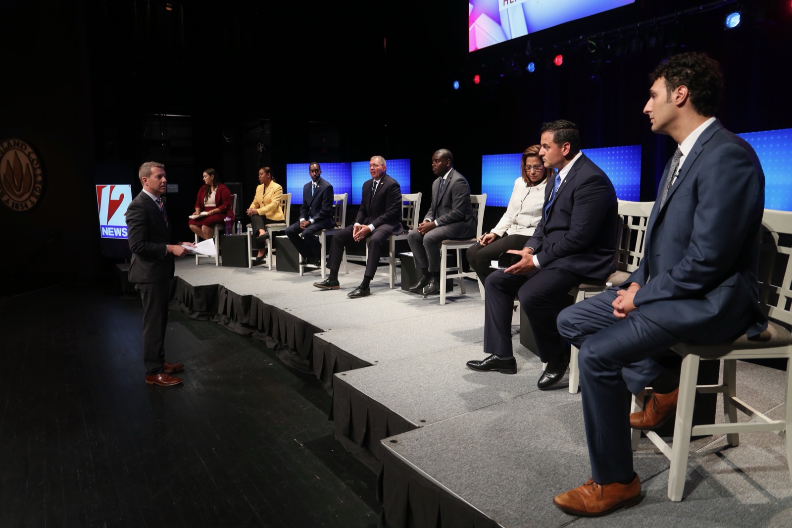 Tim White moderating a political debate