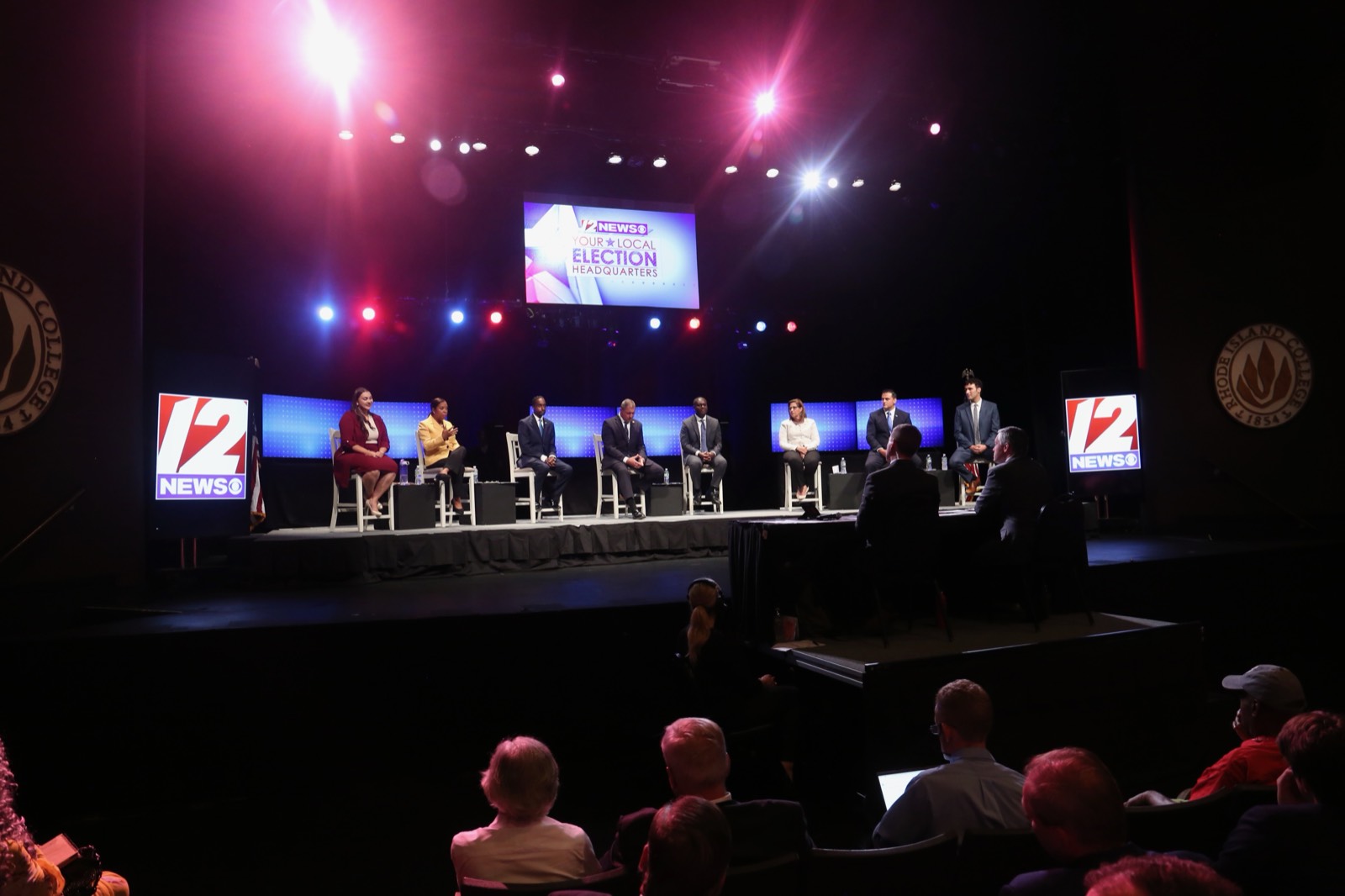 Tim White moderating a candidate debate at Rhode Island College